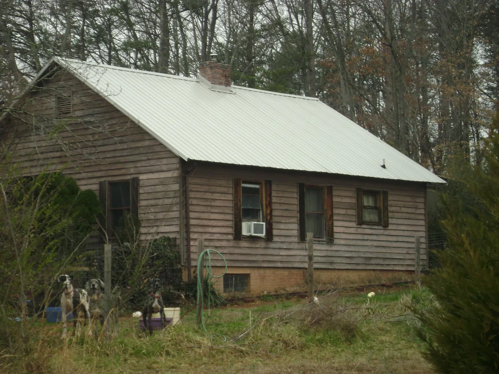 White metal roof on an old wood sided farmhouse, from a Metal Roof Installation job in Medaryville